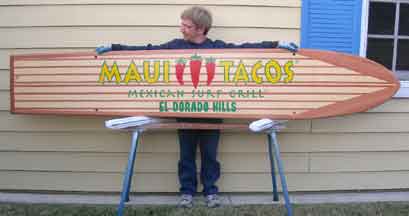 Wood surfboad with Maui Tacos Artwork